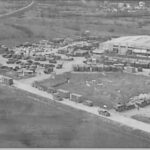 Aerial view of Guardian Base, the main logistics hub for U.S. forces in Bosnia-Herzegovina, showing cargo trucks, shipping containers, and the Logistics Task Force headquarters building. U.S. Army photo, Army Logistician, November-December 1997.