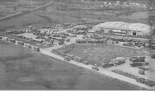Aerial view of Guardian Base, the main logistics hub for U.S. forces in Bosnia-Herzegovina, showing cargo trucks, shipping containers, and the Logistics Task Force headquarters building. U.S. Army photo, Army Logistician, November-December 1997.